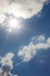 sun flares through clouds