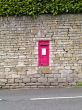 red postbox in a wall