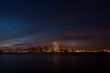 view of a illuminated city and sea at night  toronto ontario canada