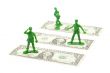 military toy soldier standing over the dollar bill