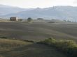 barn in a field with mountain range
