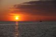 image of watercraft in sea at sunset