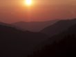 silhouette of mountains and sun