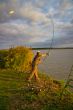 fisher with rod near the river