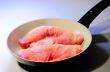 the meat in frying pans