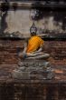 Buddha statue holding a plumeria flowers