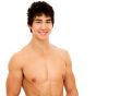 Smiling young man with muscular and tanned naked torso.
