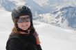 Young woman in ski clothes - mountains in the background