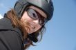 Portrait of a smiling young woman wearing ski helmet