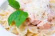 a plate of pasta decorated with basil