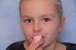 Beautiful small girl eating sweetmeat
