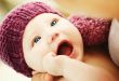 Beautiful newborn baby in a knit hat with beautiful blue eyes