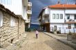 Girl runs on the street of the seaside town to the sea