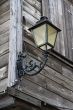 Street lantern on the wall of wooden house