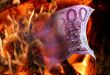 The wood fire burns a five hundred euro banknote