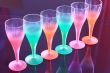 Colored glasses are on the table made â€‹â€‹of black glass.