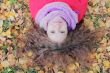 Young woman with autumn leaves