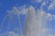 Water jets of a fountain on the blue sky