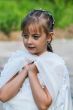 Elegant girl 7 years standing on the street.