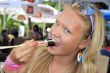 Pretty young blonde eats sushi.