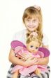Beautiful little girl playing with a doll