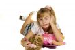 Beautiful little girl playing with a doll.