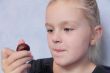 Beautiful small girl eating sweetmeat