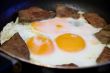 Fried eggs and meat for breakfast