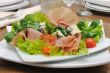 Appetizer with slices of jamon and blue cheese with cherry