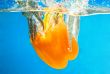 YELLOW PEPPER SPLASHING IN WATER 