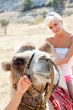 A girl riding a camel