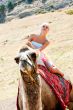 A girl riding a camel