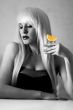 Beautiful blonde in a bar drinking tequila