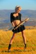 Sexy blonde girl with the bat against the sky