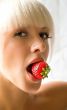 Woman eating a strawberry