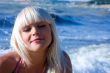 The beautiful blonde the girl against the sea