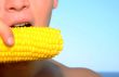 man eating corn