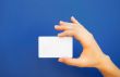 Hand holding a blank card 