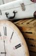 Vintage white suitcase on the box with clock