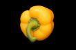 Raw peppers on black background