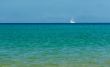 white sailboat on the azure sea