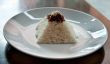 pyramid of rice on a plate in a restaurant with a worn table