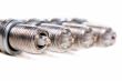 Four automobile spark plugs closeup