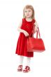 Fashion little girl with a red handbag, in catwalk model pose