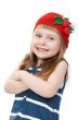 beautiful little girl in a red hat with a pattern of strawberrie