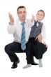 businessman and his son pulled his hands in the studio