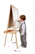 A child paints on an easel in the studio