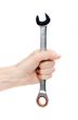Woman`s hand holding a chrome wrench.