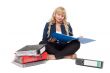 Beautiful girl sitting on the floor with folders for documents