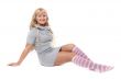 Young beautiful blonde in a striped socks sits on the floor in t